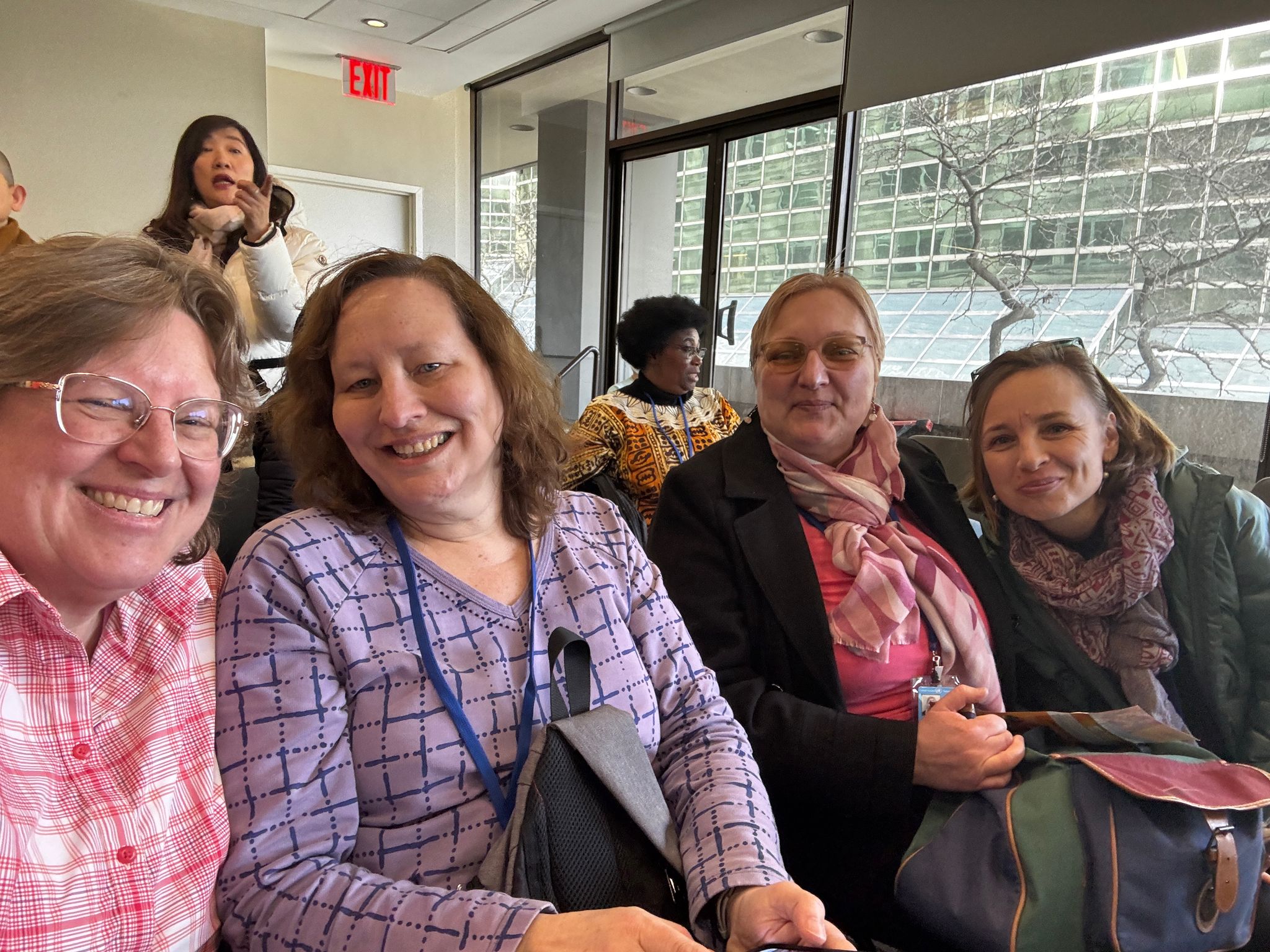 ICUUW at CSW at the United Nations 2025 - 6 women in a classroom smiling at camera
